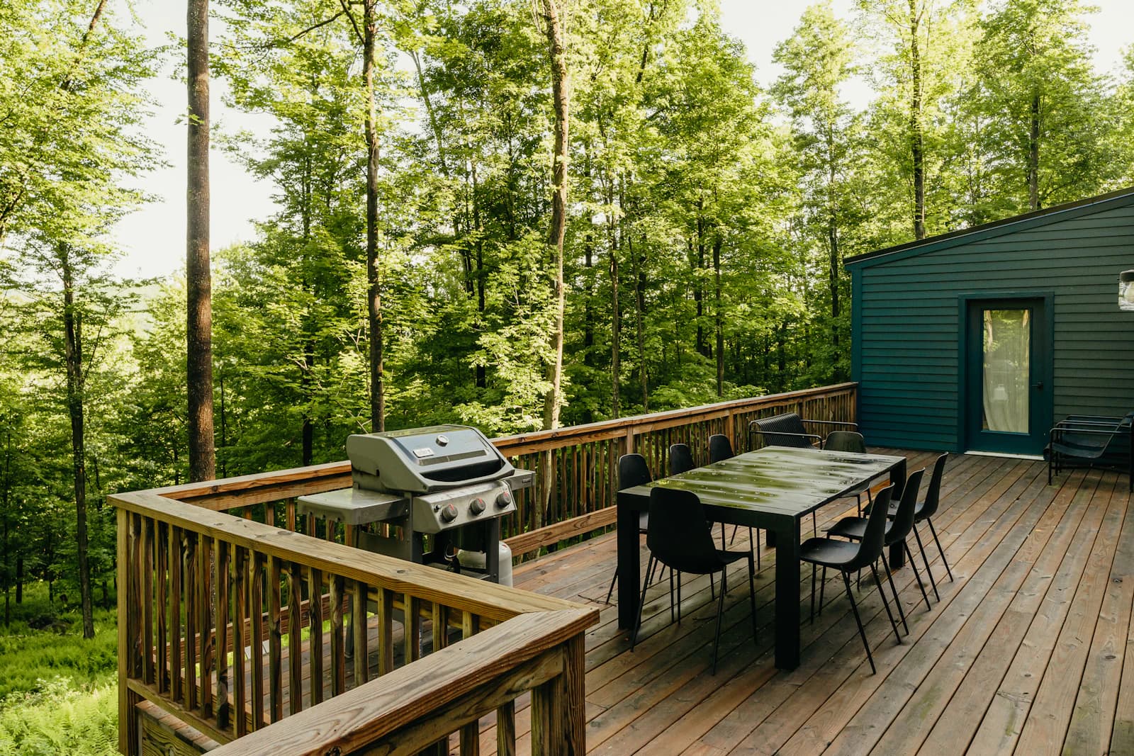 A wooden deck with a table and chairs, set up for long-term outdoor use