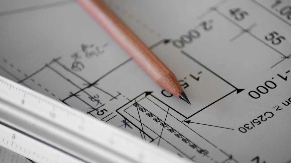 Construction drawing with dimension lines, a pencil, and a ruler