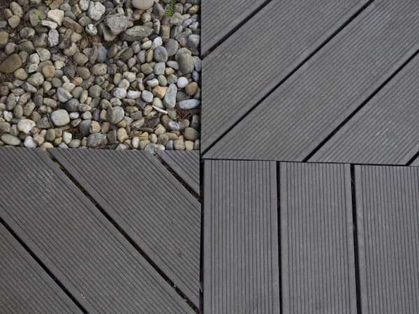 Capped composite deck boards in a wood-tone finish