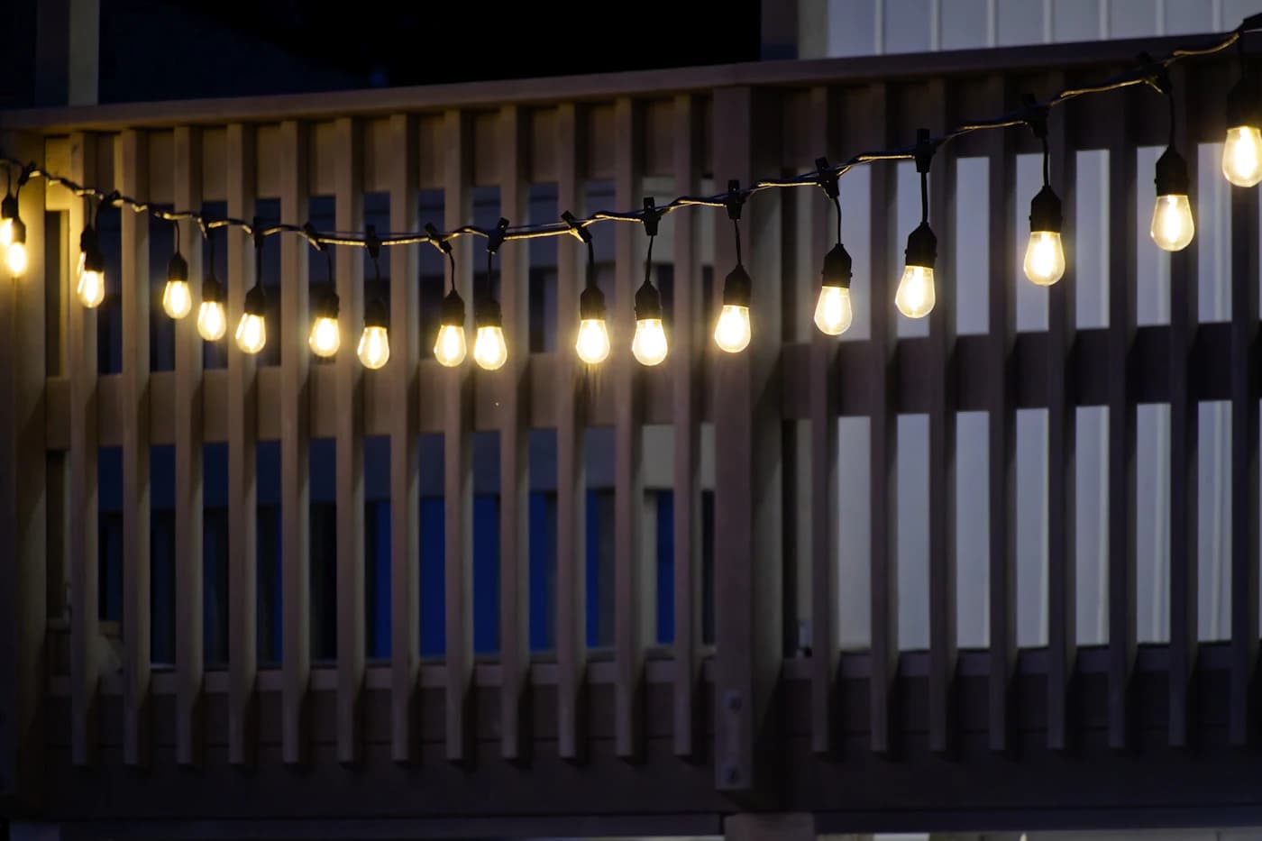 Composite deck lit at dusk — best composite decking brands compared