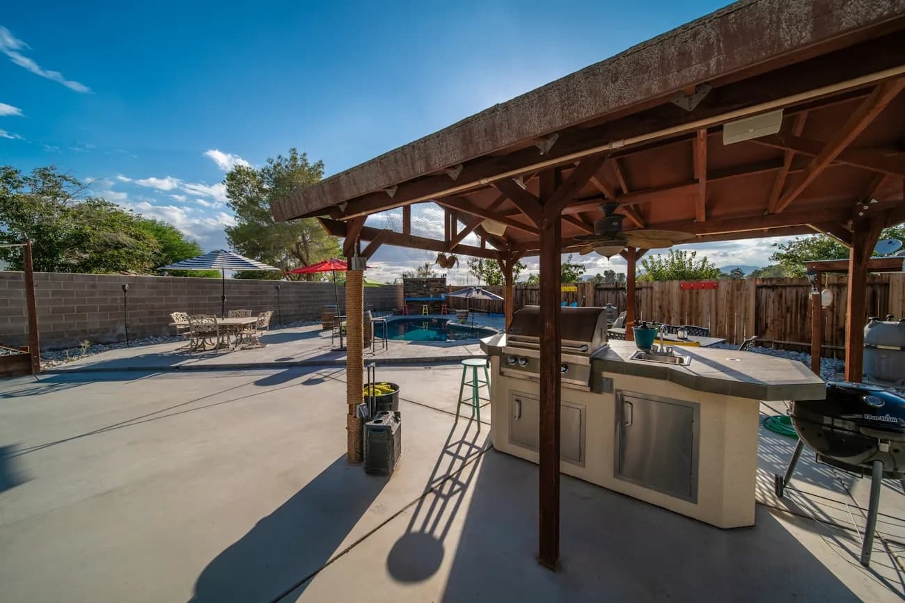 Covered deck with a solid wood roof over an outdoor kitchen