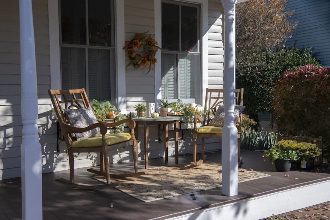 Screened covered porch with table and chairs
