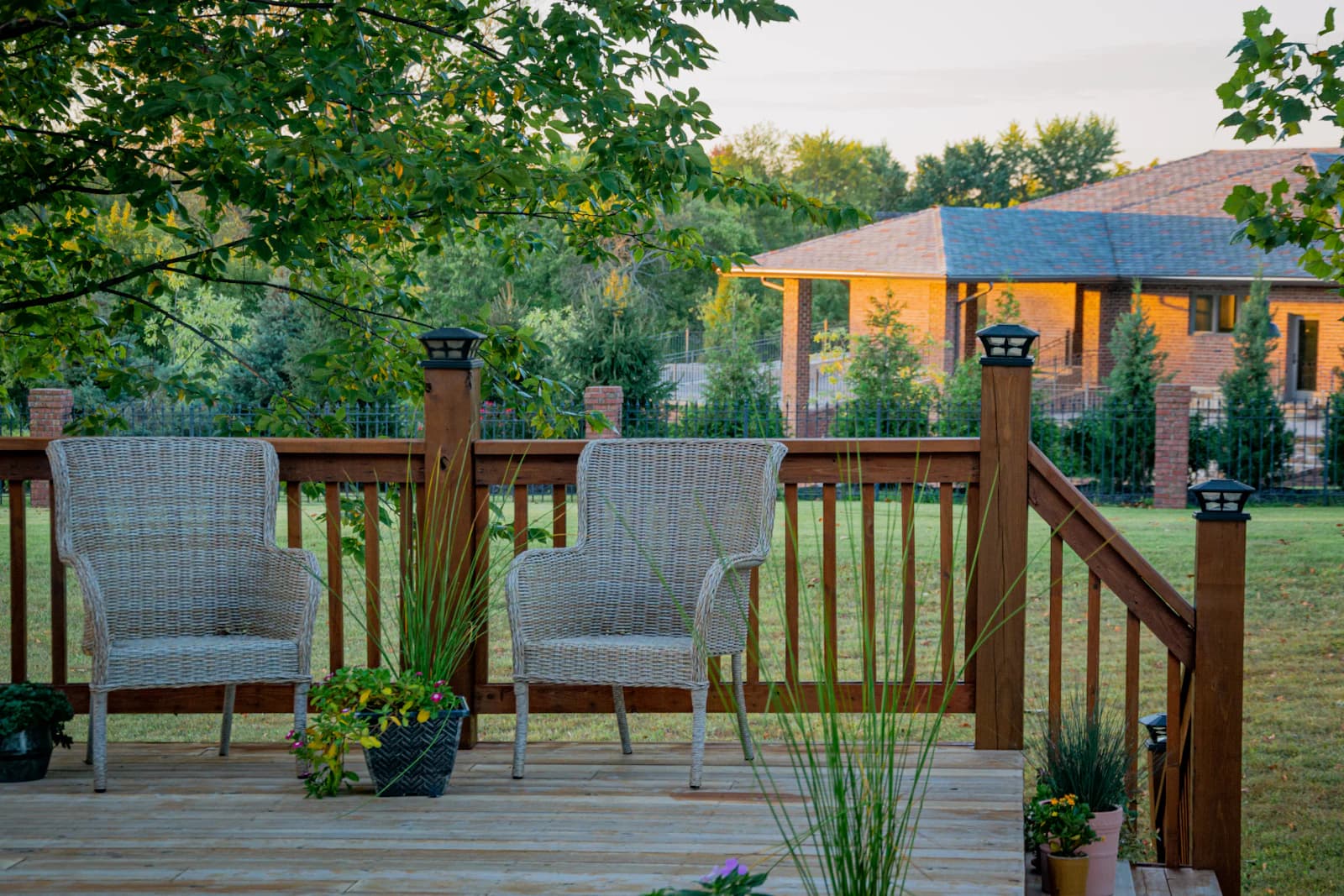 Natural cedar-tone wood boards and posts in an outdoor setting framed by green trees