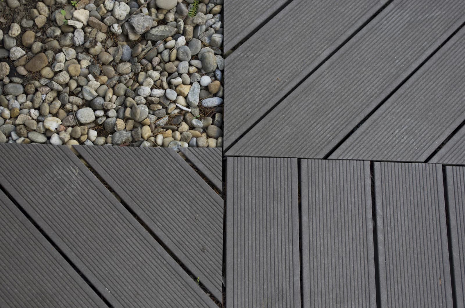 Close-up of two different wood-grain decking boards laid side by side for comparison