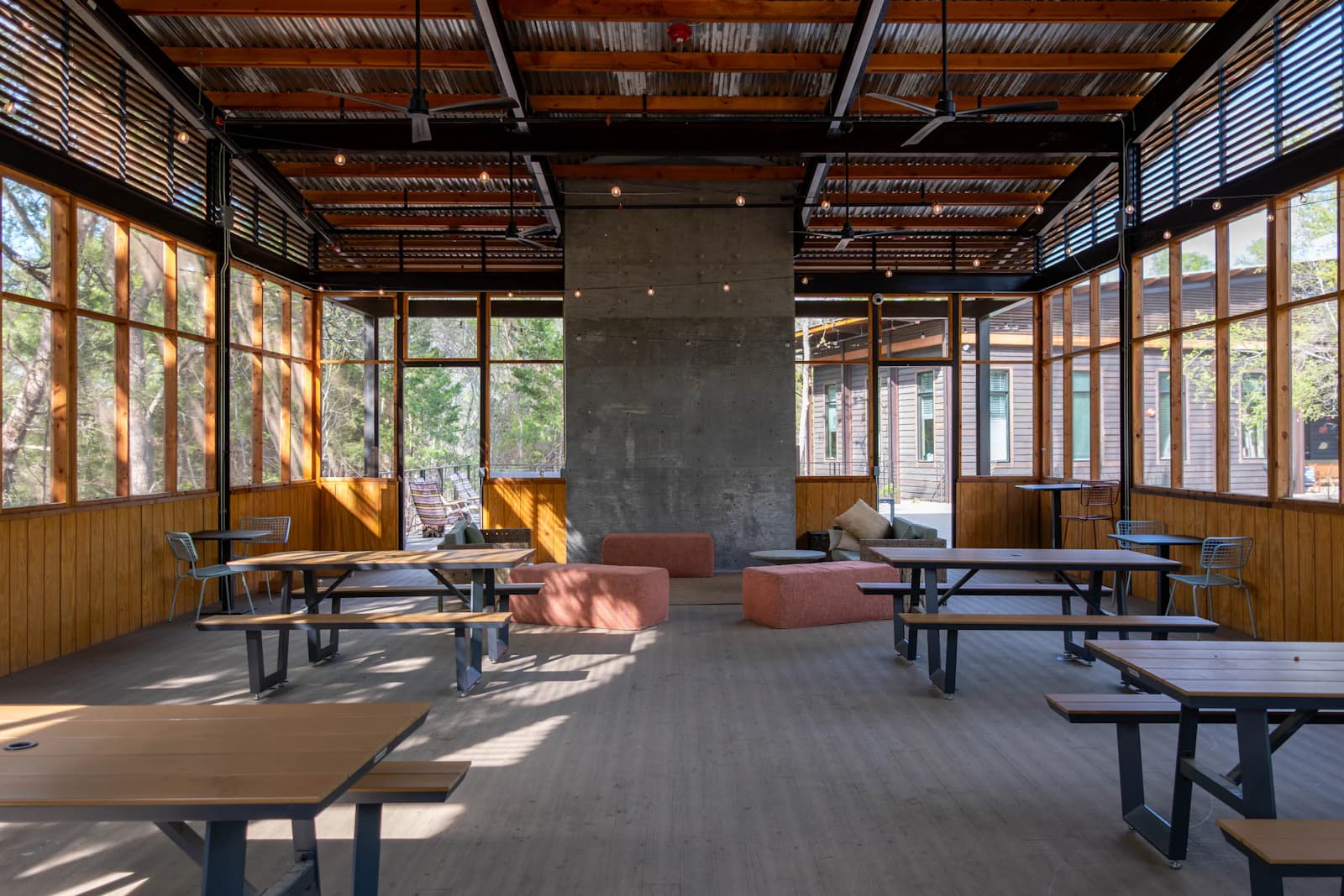 A deck under a solid roof cover with a dining set, protected from sun and rain
