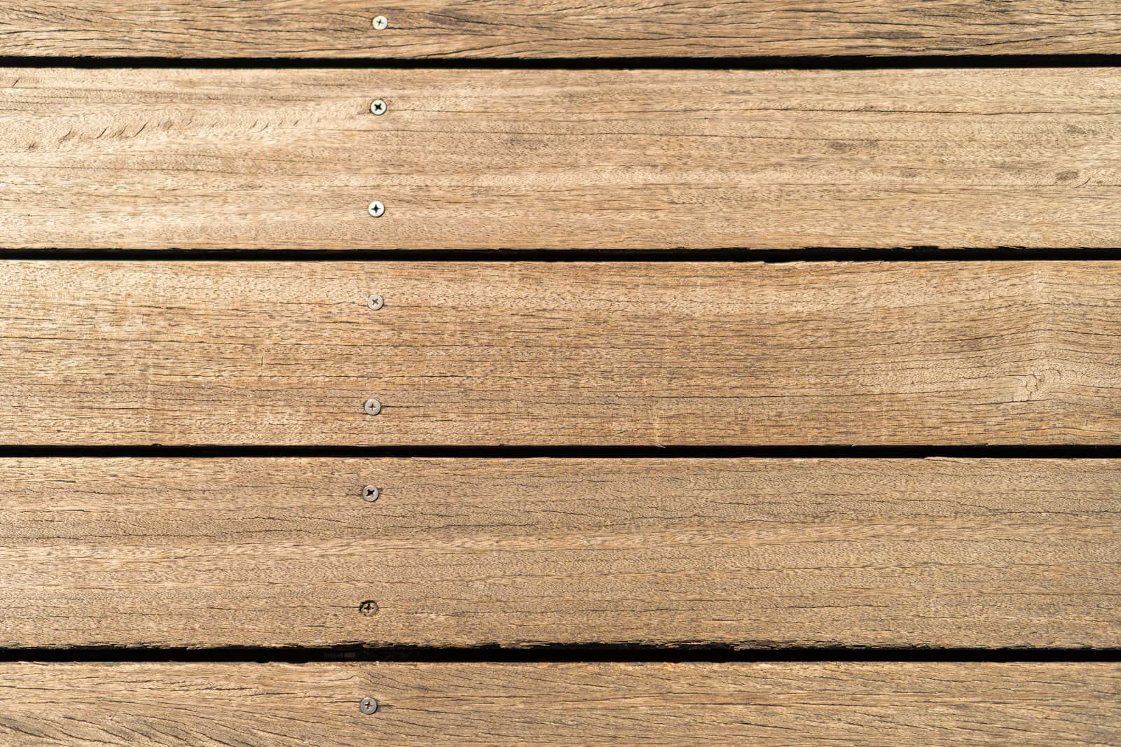 Close-up of a wooden deck surface being finished
