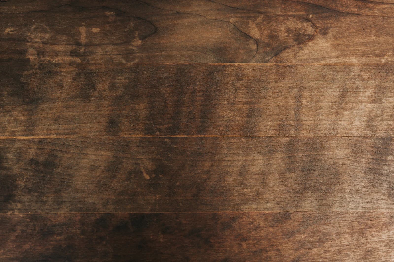 Close-up of dense, richly grained tropical hardwood decking boards in a deep brown tone