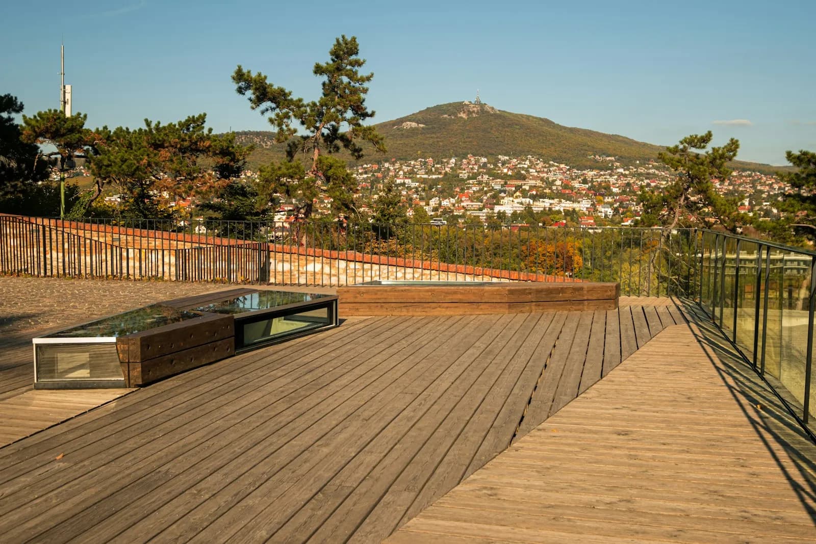 A warm-toned wooden deck with a table, in a natural hardwood finish